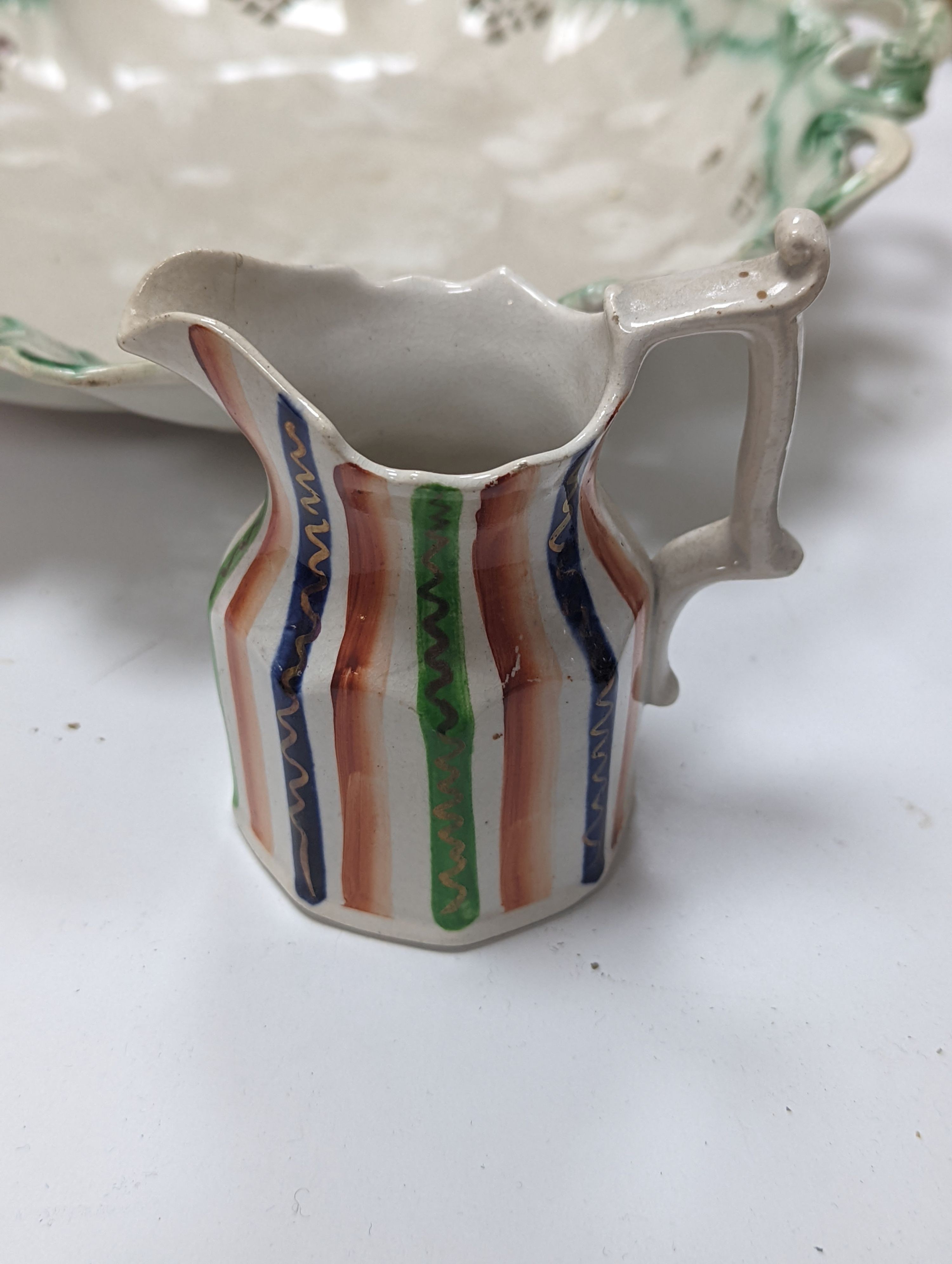 An English 18th century creamware chestnut dish and stand and a serpentine dish, A gilt decorated jug and basin and a teapot, jug and basin set, 30cms high